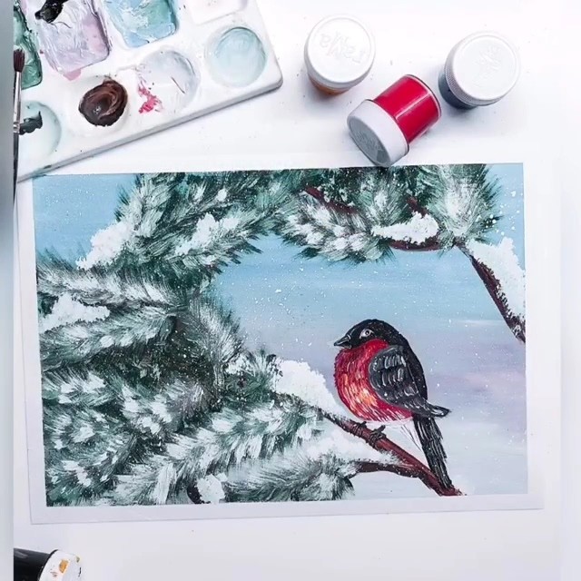 Снегирь на заснеженной ветке